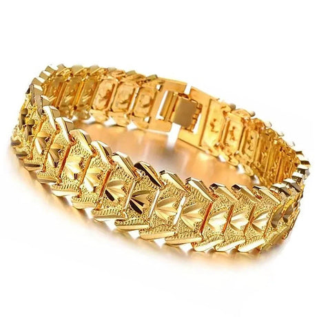 Gold bracelet with intricate design on a white background
