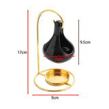 Black ceramic vase with gold stand and measurements on a white background