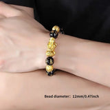 Gold and black beaded bracelet on a wrist with bead diameter text overlay