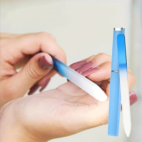 Person using a blue and white nail file on their fingernail with a plain background