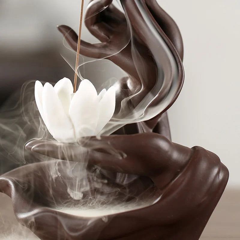 Incense burner with white lotus-shaped incense stick and smoke on a neutral background