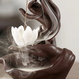 Incense burner with white lotus-shaped incense stick and smoke on a neutral background