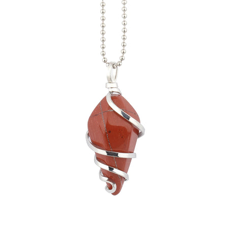 Red stone pendant with silver swirl design on a white background