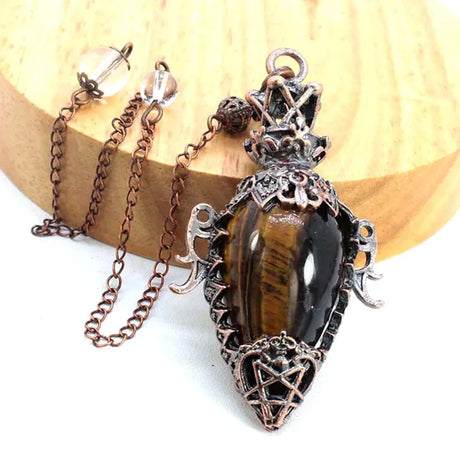 Decorative pendant with chain on a wooden surface