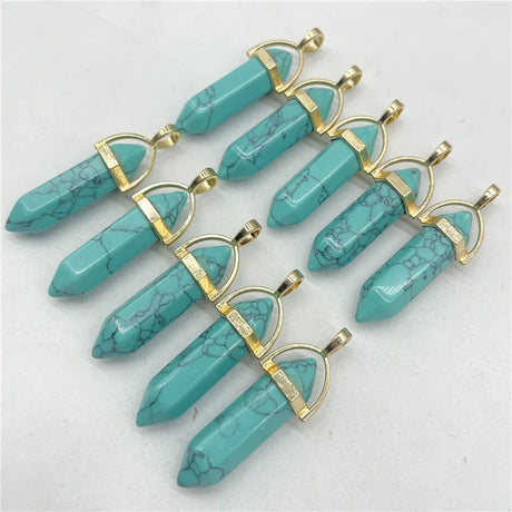 Turquoise stone pendants with gold accents on a white background