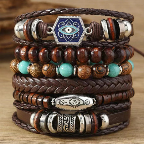 Stack of leather and beaded bracelets with decorative elements on a wooden surface