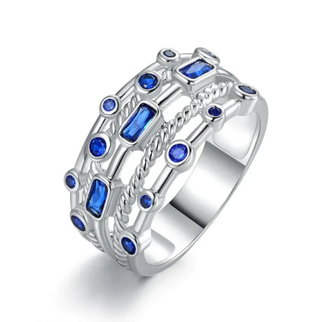 Silver ring with blue gemstones on a white background