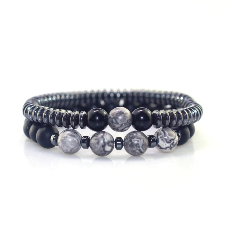 Set of three beaded bracelets with black, gray, and white stones on a white background
