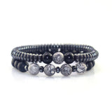 Set of three beaded bracelets with black, gray, and white stones on a white background