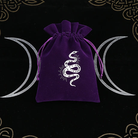 Purple drawstring bag with a snake design on a black background with moon symbols.