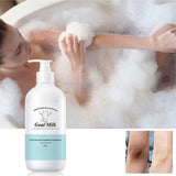 Person in a bubble bath with a bottle of goat milk shower gel.