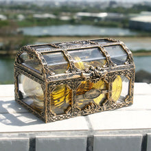 Decorative chest with gold coins on a surface outdoors