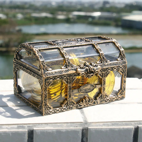 Decorative chest with gold coins on a surface outdoors
