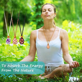 Woman meditating outdoors with necklaces featuring stones in the foreground