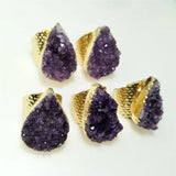 Purple geode earrings with gold bases on a white background