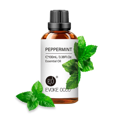 Evoke Occu peppermint essential oil bottle with leaves on a white background