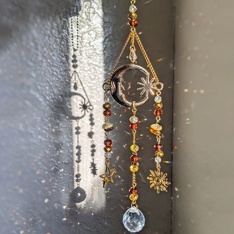 Decorative hanging ornament with beads and celestial designs on a textured surface