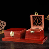 Wooden jewelry box with intricate design on a dark background