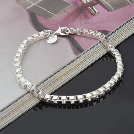 Silver bracelet on a magazine with a blurred background