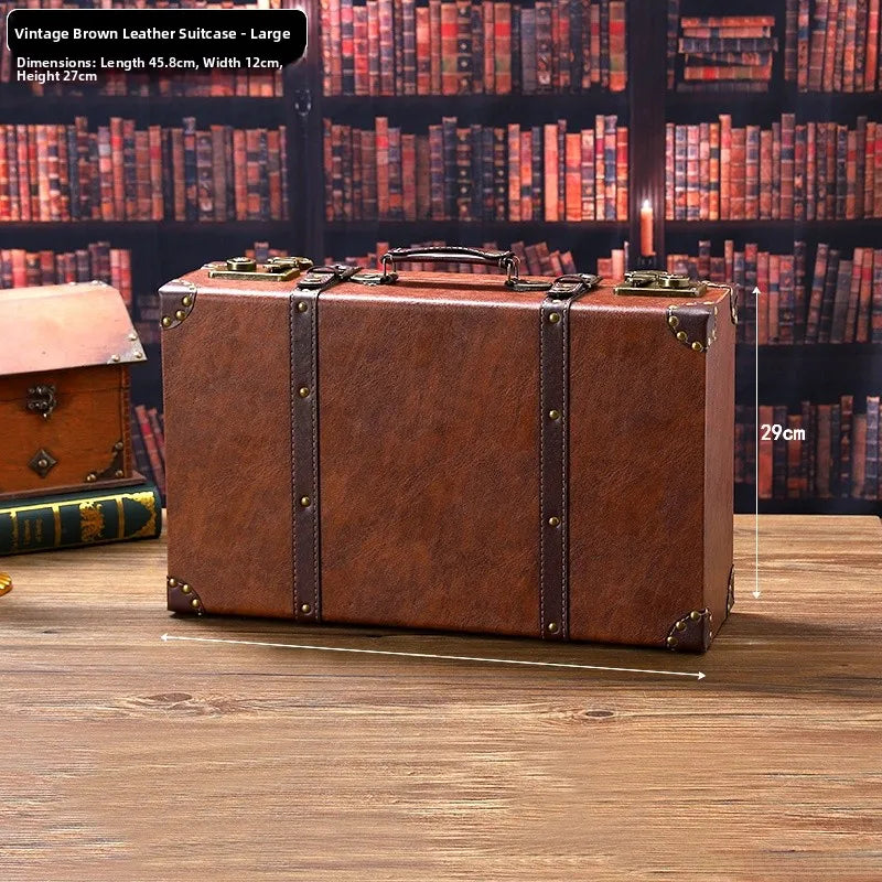 Vintage brown leather suitcase on a wooden surface with a bookshelf background