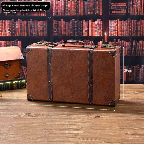 Vintage brown leather suitcase on a wooden surface with a bookshelf background