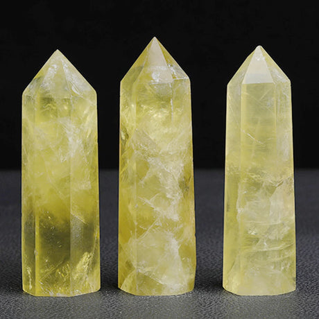 Three yellow crystal towers on a dark background