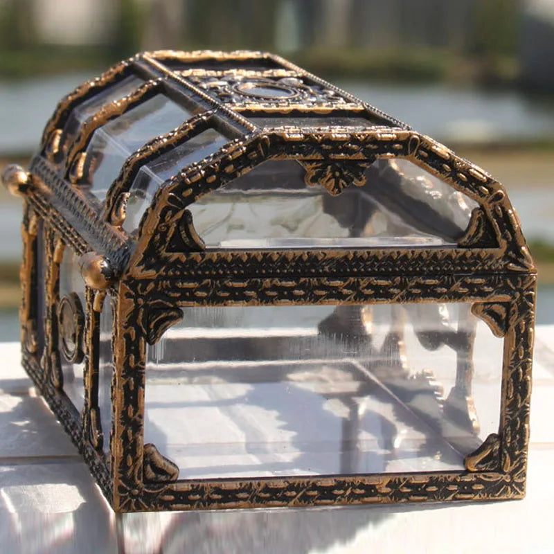 Decorative glass box with ornate bronze frame on a blurred natural background