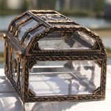 Decorative glass box with ornate bronze frame on a blurred natural background