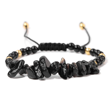 Black beaded bracelet with gold accents on a white background