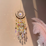 Decorative hanging ornament with crystals and feathers on a soft background
