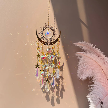 Decorative hanging ornament with crystals and feathers on a soft background