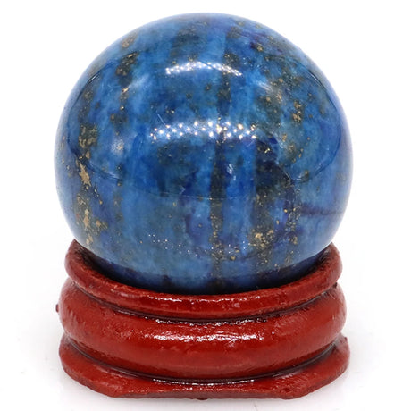 Blue crystal sphere on a red stand against a white background