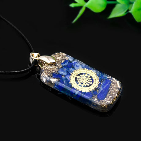 Lapis lazuli pendant with Sri Yantra symbol on a black background