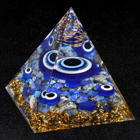Pyramid-shaped object with blue eyes and copper coil on a black background