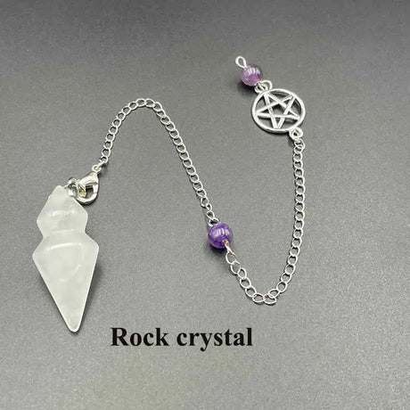 Pendant with rock crystal and pentagram design on a chain against a gray background