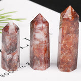 Three crystal towers with red and white patterns on a white surface.
