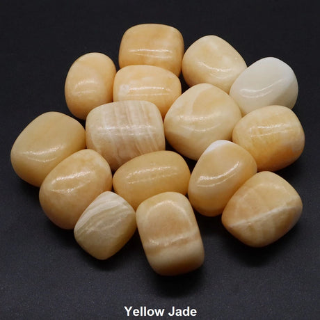 Yellow jade stones on a black background