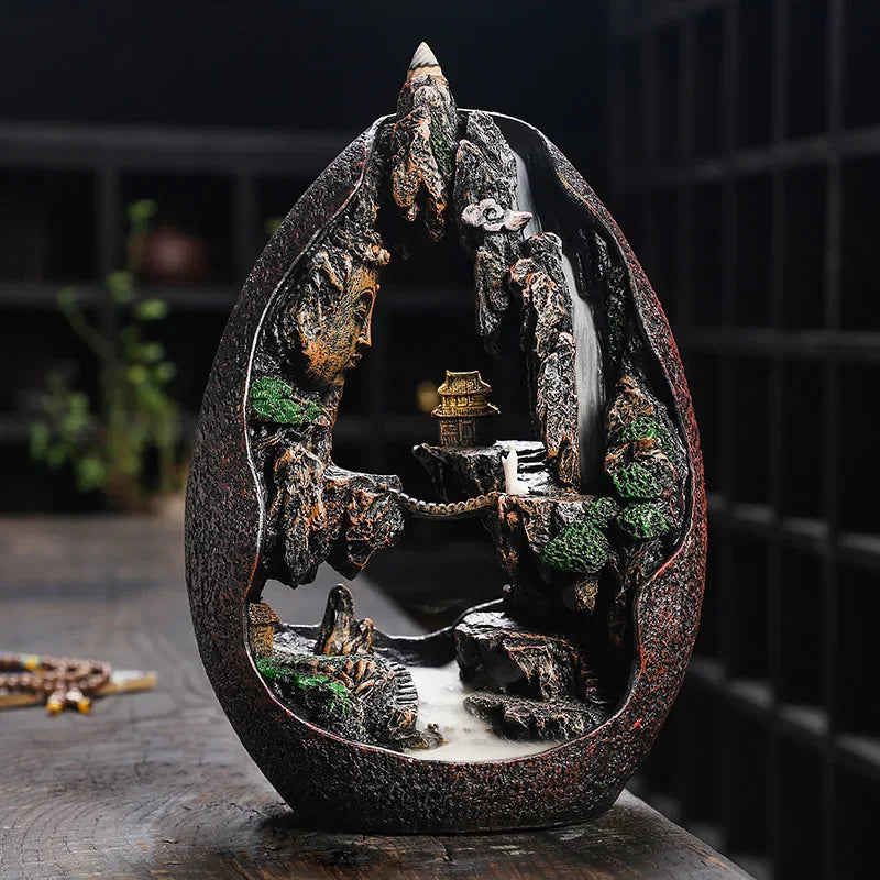 Decorative stone sculpture with a small temple and water feature on a dark background
