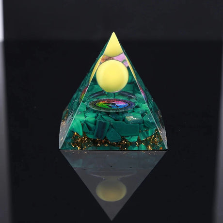 Triangular pyramid with green and gold interior on a black background