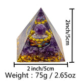 Pyramid-shaped crystal object with measurements and weight information on a white background
