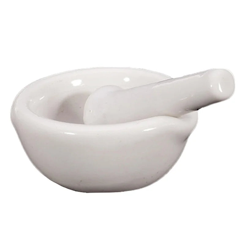 White ceramic mortar and pestle on a white background