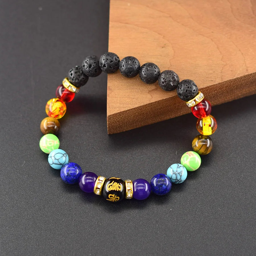 Multicolored beaded bracelet on a dark surface with a wooden block