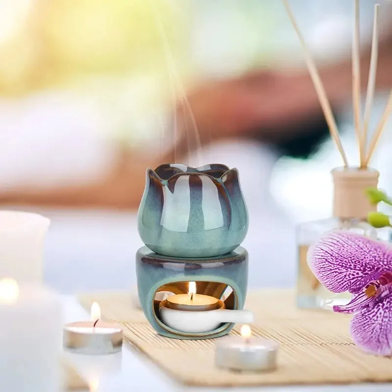 Aromatherapy diffuser with candles and reeds on a wooden surface