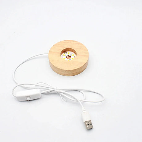 Wooden circular device with a USB cable on a white background