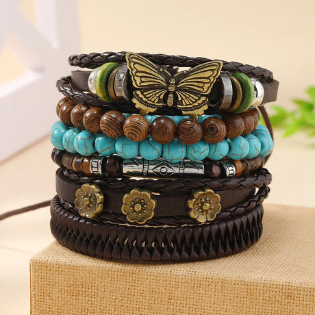 Stack of colorful bracelets with butterfly and floral designs on a beige surface.