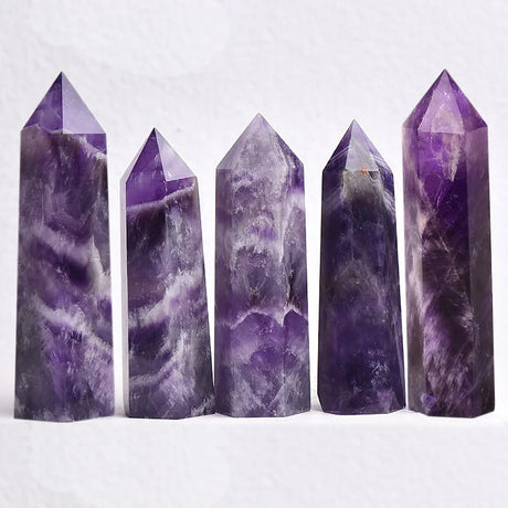 Five purple crystal towers on a white background
