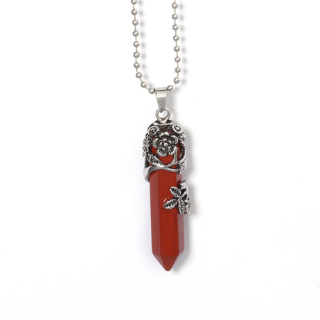 Necklace with a red crystal pendant and silver floral elements on a white background