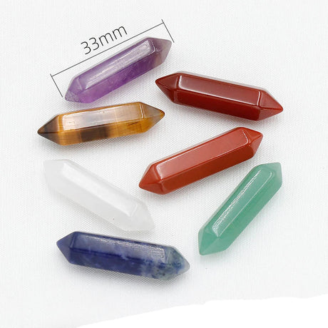 Set of colorful crystal points on a white background with measurement label.