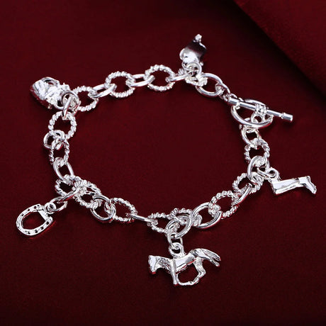 Silver bracelet with horse charm on a red background