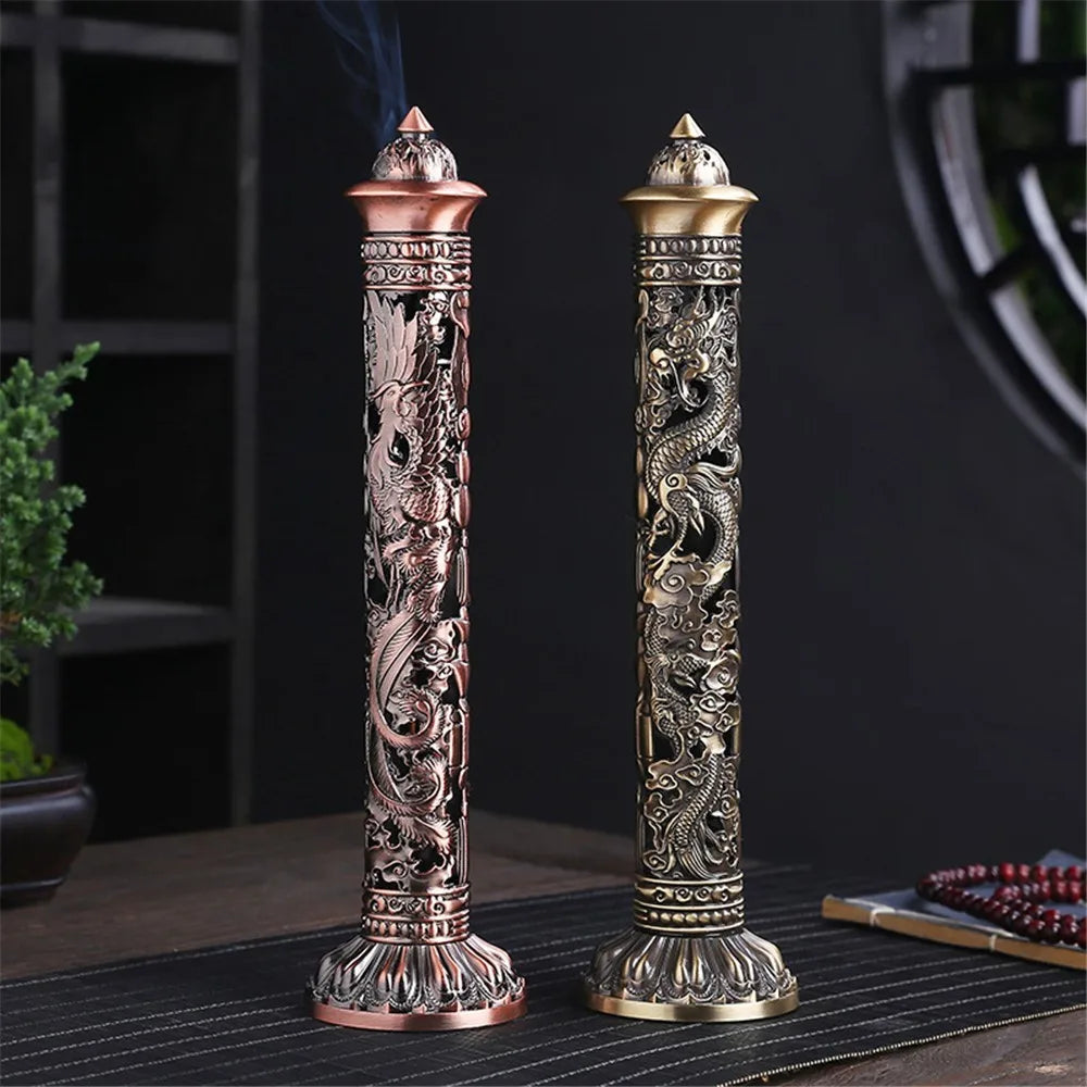 Two intricately designed incense sticks on a dark surface with a blurred background